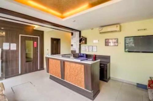 a kitchen with an island in the middle of a room at Collection O Hotel Kashi Inn in Varanasi