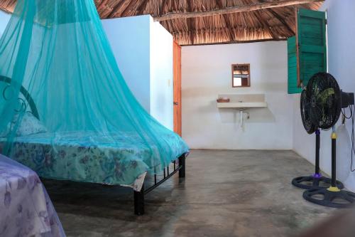 a bedroom with a bed with a mosquito net at Las Palmas in Bacalar