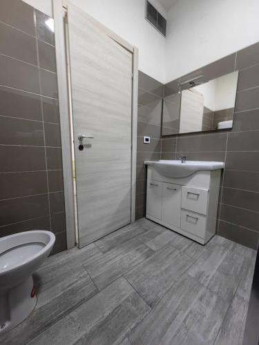 a bathroom with a toilet and a sink and a shower at MILANFORESTER in Milan