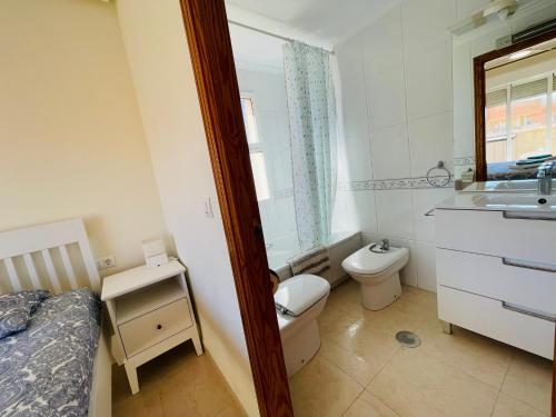 a small bathroom with a toilet and a sink at Puerto Mar Fase I - Atico in La Manga del Mar Menor