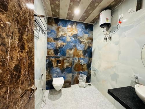 a bathroom with a sink and a toilet in it at Shree Yog Maya Resort in Pushkar