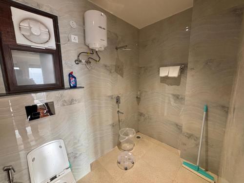 a bathroom with a shower with a sink and a mirror at 4 BHK Mountain View Villa In Rishikesh in Rishīkesh