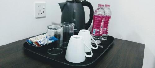 a black table with a blender and bottles on it at The Inn At Matale in Matale