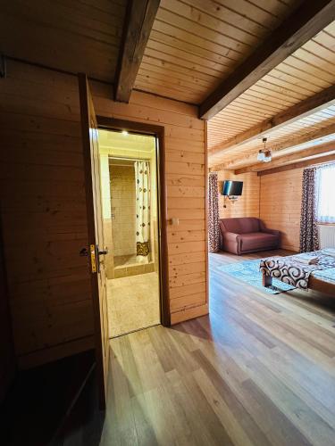 an open door to a bedroom with a bed in a room at Guest House Lileya in Bukovel