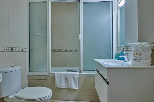 a bathroom with a toilet and a sink and a shower at YourPlace Rabat Agdal 1 - Cozy Residence in Rabat