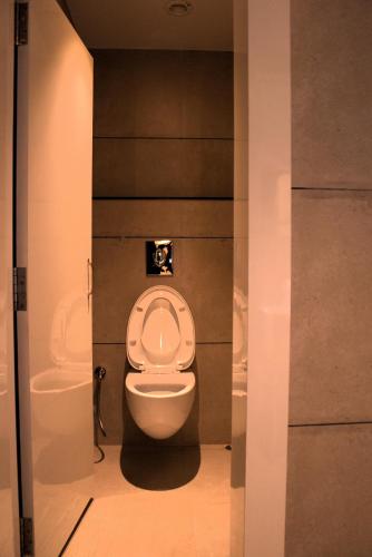 a bathroom with a toilet and a sink at Hotel Tanisha in Kishanganj Bazar