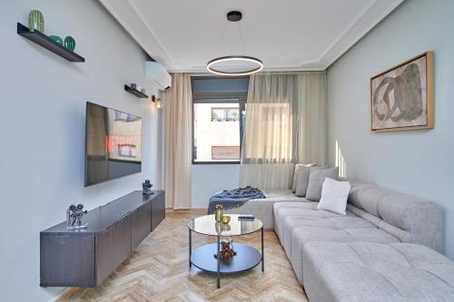 a living room with a couch and a table at YourPlace Rabat Agdal 1 - Cozy Residence in Rabat