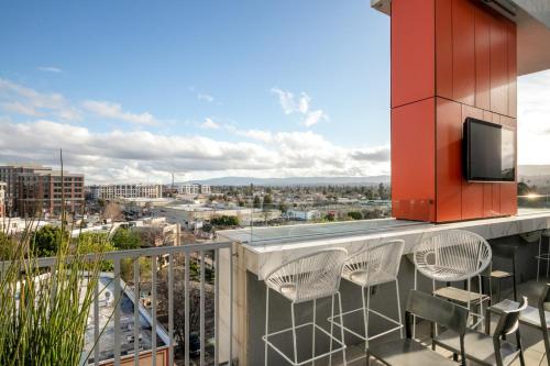 a balcony with chairs and a tv on a building at Redwood City 1BR w Gym WD next to Caltrain SFO-1046 in Redwood City