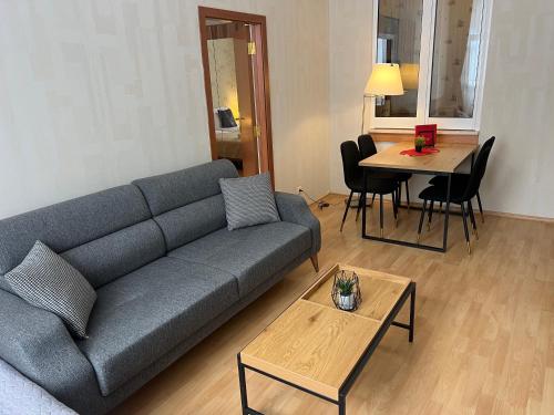 a living room with a couch and a table at Flora Hotel Apartment 103 in Borovets
