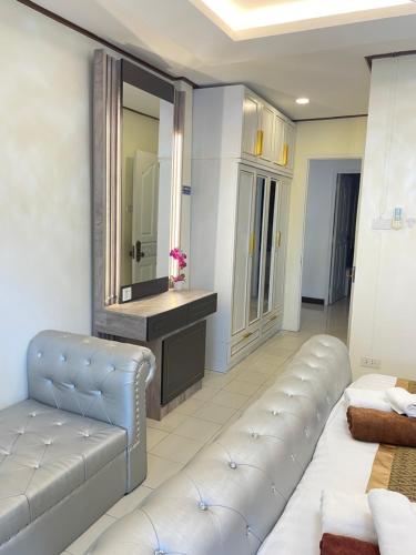 a living room with a couch and a mirror at Pattaya Pool Villa39A 300 mater to beach gate exit in Pattaya South