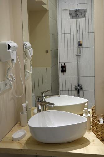 a bathroom with a large white tub and a shower at Eva's Pavaroti in Tbilisi City