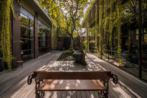 a wooden bench sitting in front of a building at Villa Manis Beachfront Candidasa in Candidasa
