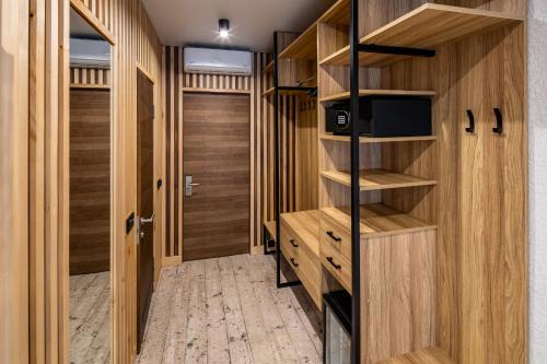 a walk in closet with wooden cabinets and a television at Wood Hotel Resort & SPA in Bukovel