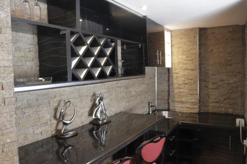 a kitchen with two sinks and two mirrors at Golden Tulip Hotel Port Harcourt -GTPH in Port Harcourt