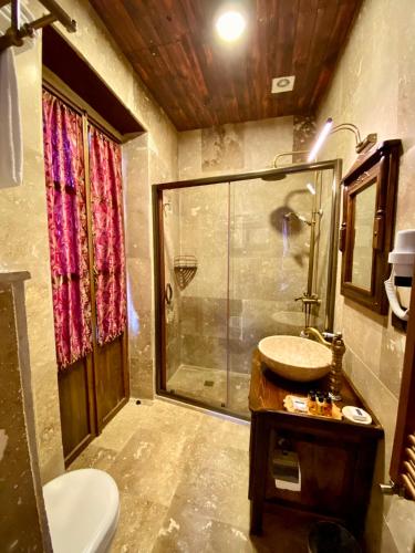 a bathroom with a shower and a sink at YOHANNES Stone Cappadocia in Ürgüp