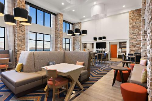 a lobby with a couch and a table and chairs at Hampton Inn & Suites Petoskey in Petoskey