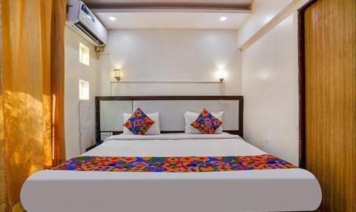 a bedroom with a large bed in a room at FabExpress Prabhu Sharan in Mumbai