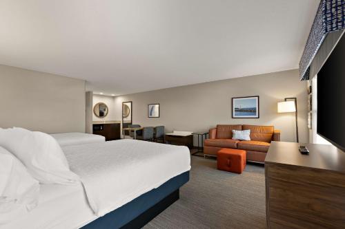 a hotel room with a bed and a couch at Hampton Inn & Suites Petoskey in Petoskey