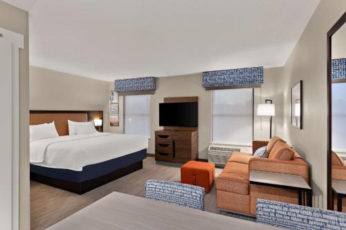 a hotel room with a bed and a tv at Hampton Inn & Suites Petoskey in Petoskey