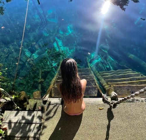 a woman looking at the fish in an aquarium at Lodge Tzunum Jade in Tulum
