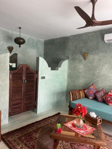 a living room with a couch and a table at Casa Paradis Boutique Hotel in Jambiani