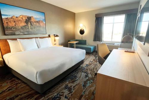 a hotel room with a large white bed and a couch at La Quinta Inn & Suites by Wyndham Yuma in Yuma