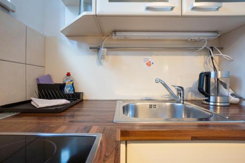 a kitchen with a sink and a counter top at Apartment with a private terrace located right near Belvedere Castle, 15 minutes away from Stephansdom in Vienna
