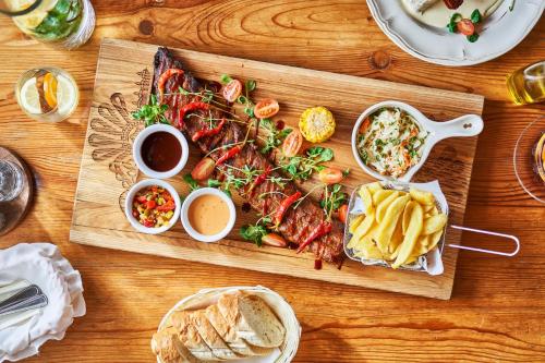 a wooden table with a cutting board filled with food at Witowianka in Witów