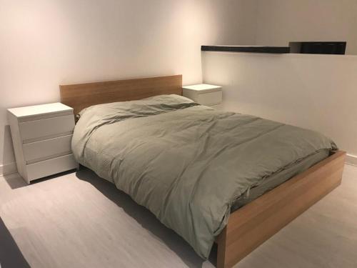 a bedroom with a large bed and two night stands at Lovely Cozy One bedroom close to city centre Liverpool in Liverpool