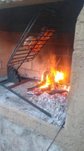 a brick oven with a fire inside of it at Mulelle cabañas in Ciudad Lujan de Cuyo