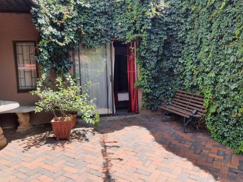 a bench sitting in front of a building at The Crooked Forest in Pretoria