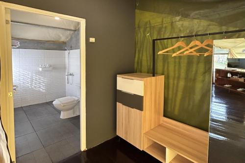 a bathroom with a shower and a toilet in it at Alinson Sunset Hill in Bogor