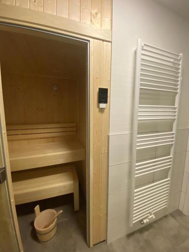 a closet with wooden shelves and a toilet in it at Dahmer Strand W 14 in Dahme