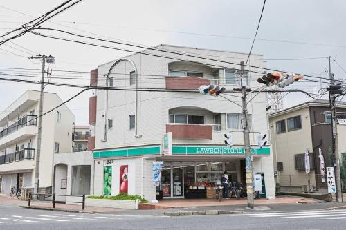a traffic light in front of a building at Sun white Gyoutoku 301 in Tokyo
