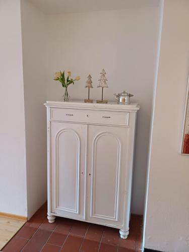 a white cabinet in the corner of a room at Haus am Sonnweg in Maurach