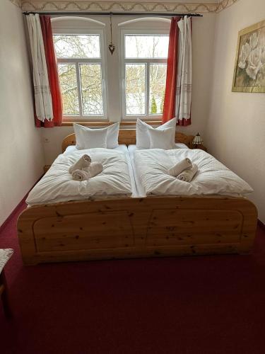 two babies laying on a large bed in a bedroom at Weißer Stein Jonsdorf in Kurort Jonsdorf