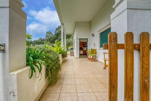 a porch of a house with a wooden fence at Abrigo do Castelo - Pica-Pau in Ourém
