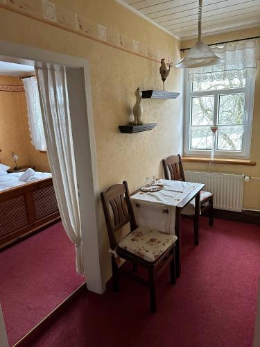 a dining room with a table and two chairs at Weißer Stein Jonsdorf in Kurort Jonsdorf