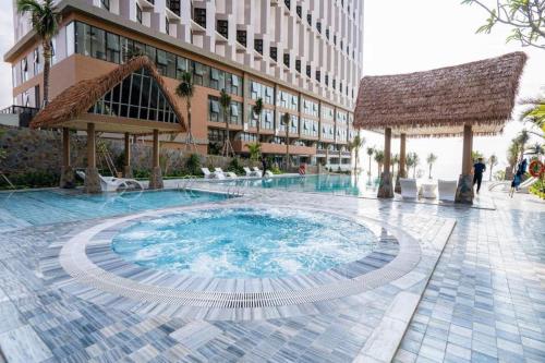 a large swimming pool in the middle of a building at Apec Mandala Mui Ne 2124 in Phan Thiet