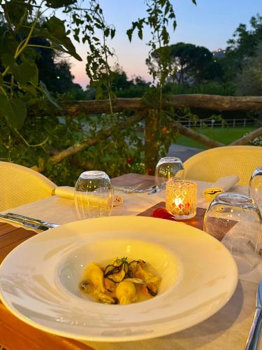 a plate of food on a table with wine glasses at Sopramare Resort in Piano di Sorrento