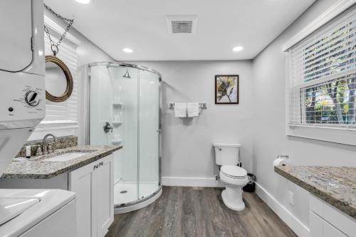 a white bathroom with a shower and a toilet at Charlotte Luxury Home NoDa in Charlotte