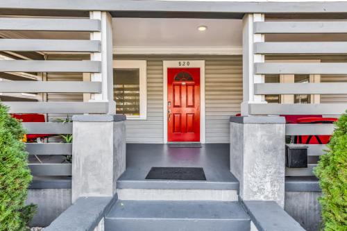 a red door on a white house with stairs at Charlotte Luxury Home NoDa in Charlotte