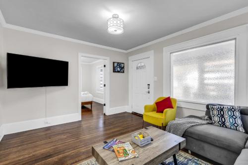 a living room with a couch and a tv at Charlotte Luxury Home NoDa in Charlotte