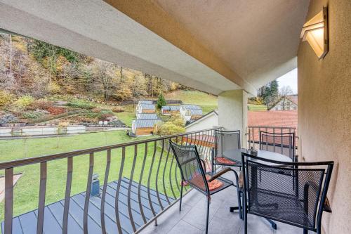 a balcony with two chairs and a table at Honeycomb Chalets And Apartments Mozirje in Mozirje