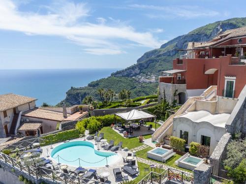 a view of a resort with a swimming pool and the ocean at Palazzo Pascal in Scala