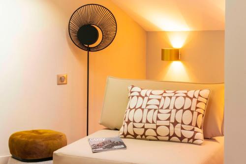 a room with a bed with a fan and a pillow at Le Saint Gervais Hotel & Spa Handwritten Collection in Saint-Gervais-les-Bains