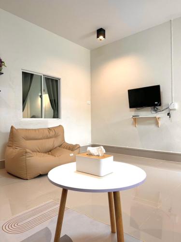 a living room with a couch and a table at Pk house and cosy - Nakarat in Betong