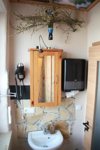 a bathroom with a sink and a tv on the wall at Danubio an der Donau - Donau-Resorium in Donauwörth