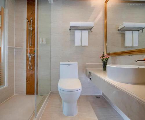 a bathroom with a toilet and a sink at President Hotel Shenzhen - Yitian Metro Station in Shenzhen