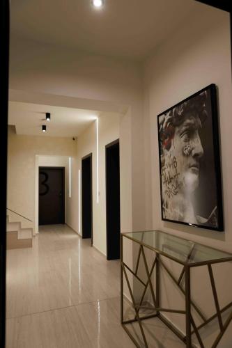 a room with a glass table and a painting on the wall at Villa Mala Praha Experience in the Center of Žilina in Žilina